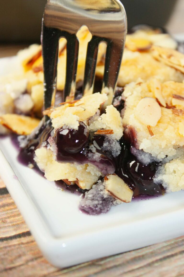 Blueberry Peach Dump Cake is bursting with juicy fruit flavour in every bite. Sweet peaches and plump blueberries mingle together under a golden, buttery cake topping. 
