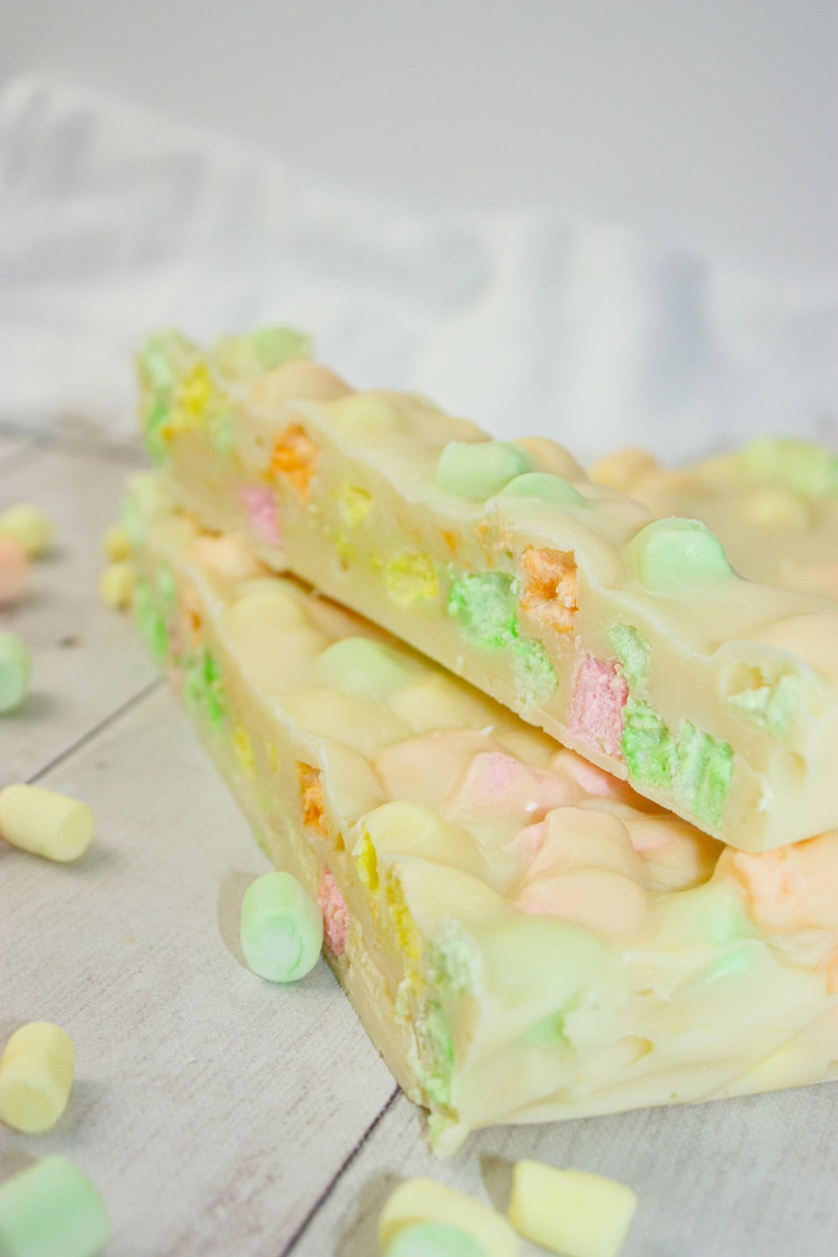 This Microwave Rainbow Fudge swirls with playful pops of fruity colour in every bite. &nbsp;The fruity mini marshmallows peek through the creamy base like tiny gems.
