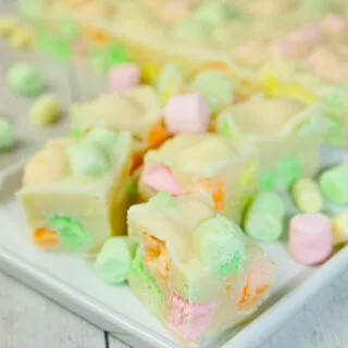 This Microwave Rainbow Fudge swirls with playful pops of fruity colour in every bite. The fruity mini marshmallows peek through the creamy base like tiny gems.
