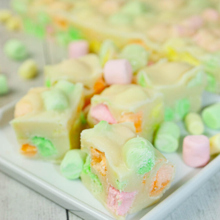 This Microwave Rainbow Fudge swirls with playful pops of fruity colour in every bite.  The fruity mini marshmallows peek through the creamy base like tiny gems.