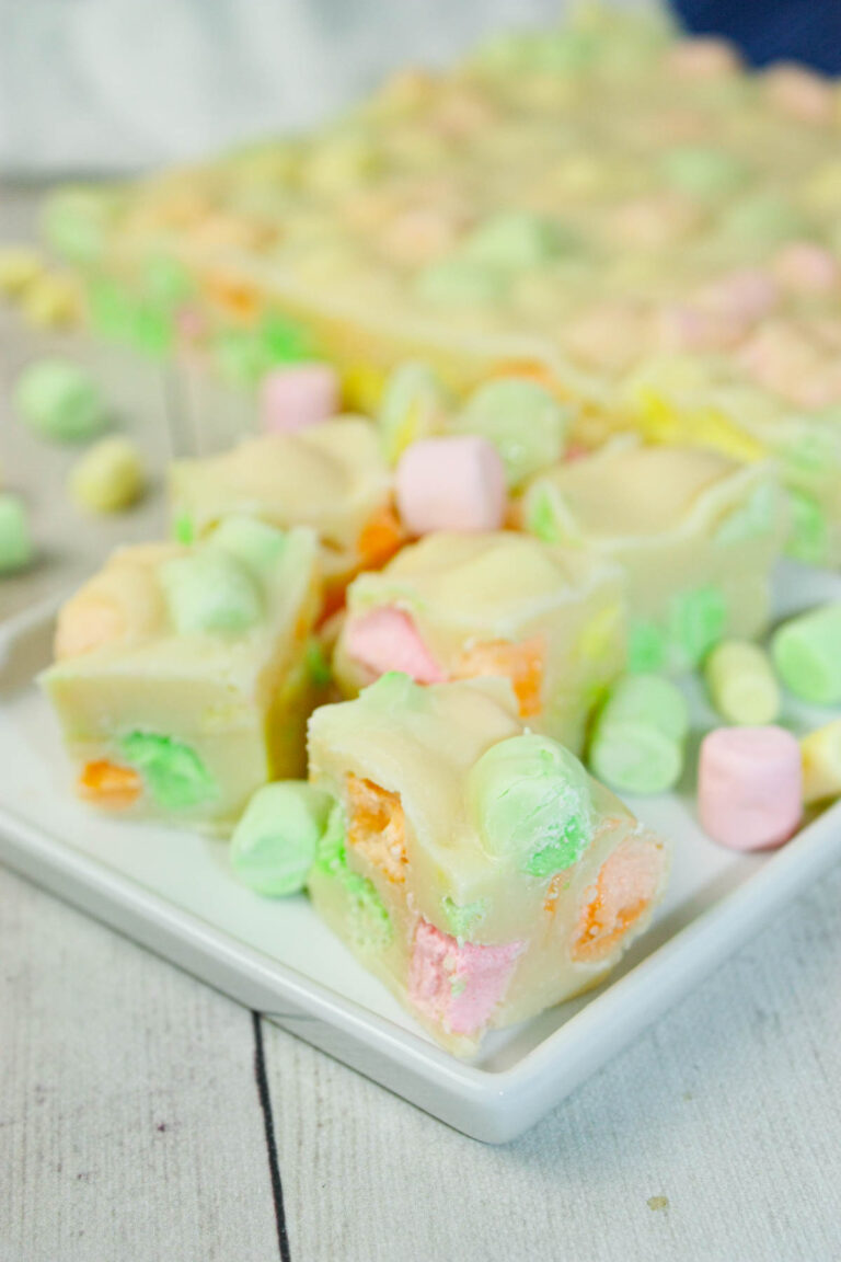 This Microwave Rainbow Fudge swirls with playful pops of fruity colour in every bite.  The fruity mini marshmallows peek through the creamy base like tiny gems.
